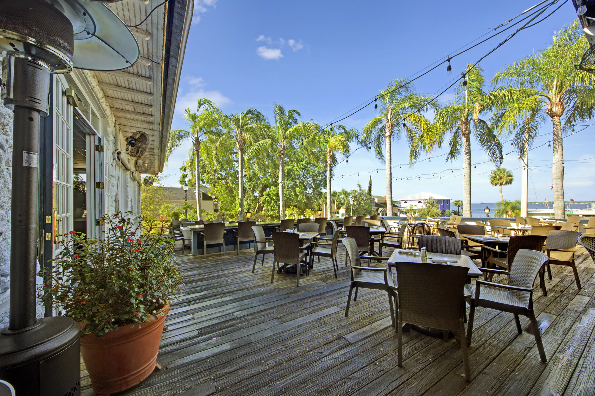 Sunshine, palm trees, and a table waiting for you on the deck at Pisces Rising in Mount Dora